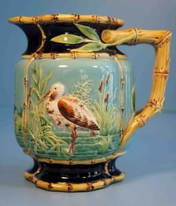 Stork in marsh pitcher with bamboo handle